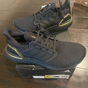 Men’s Adidas Ultraboost 20 in black and gold